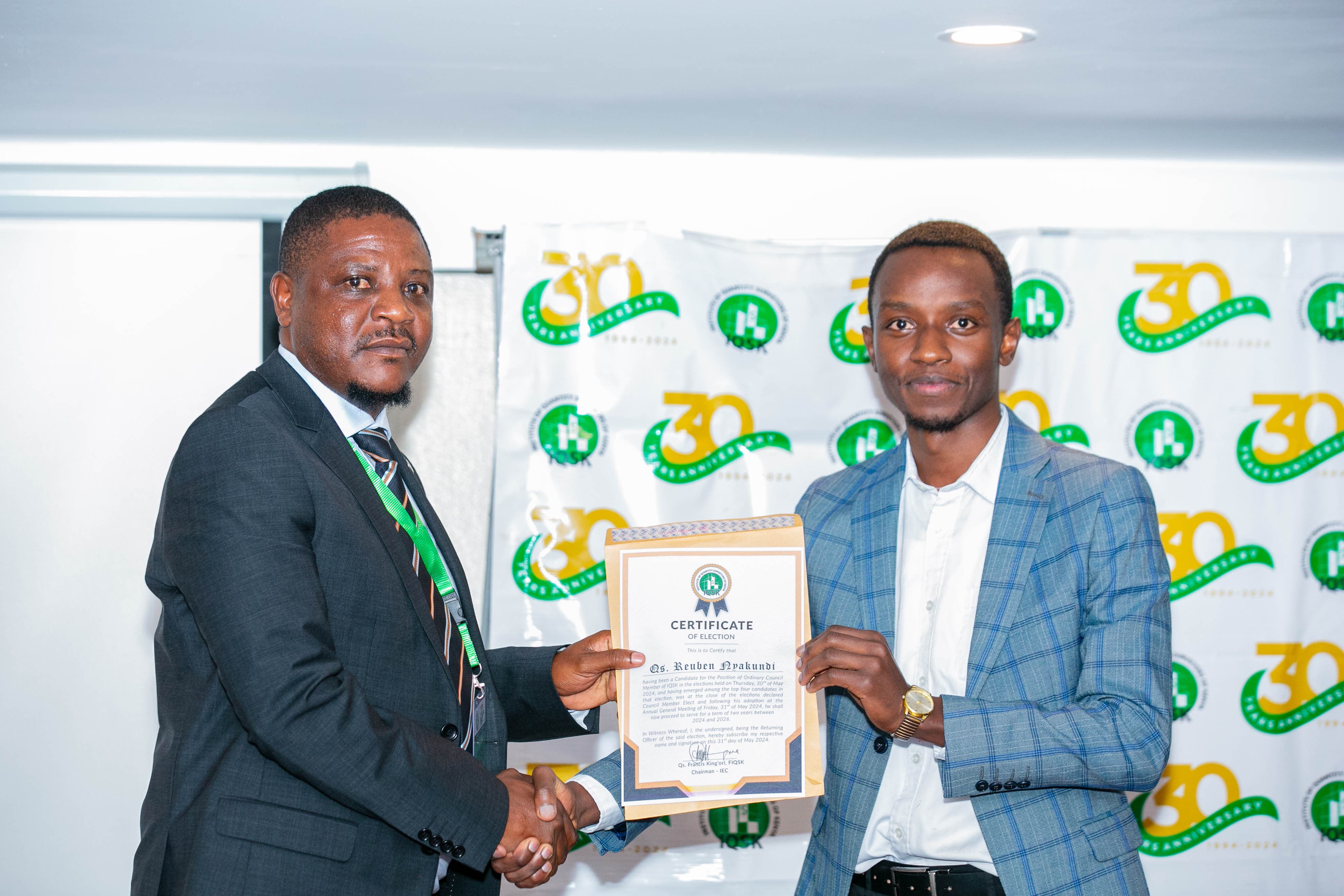 Qs. Reuben Nyakundi receives his Certificate of Election from Commissioner Grad. Qs. Ernest Nyakundi