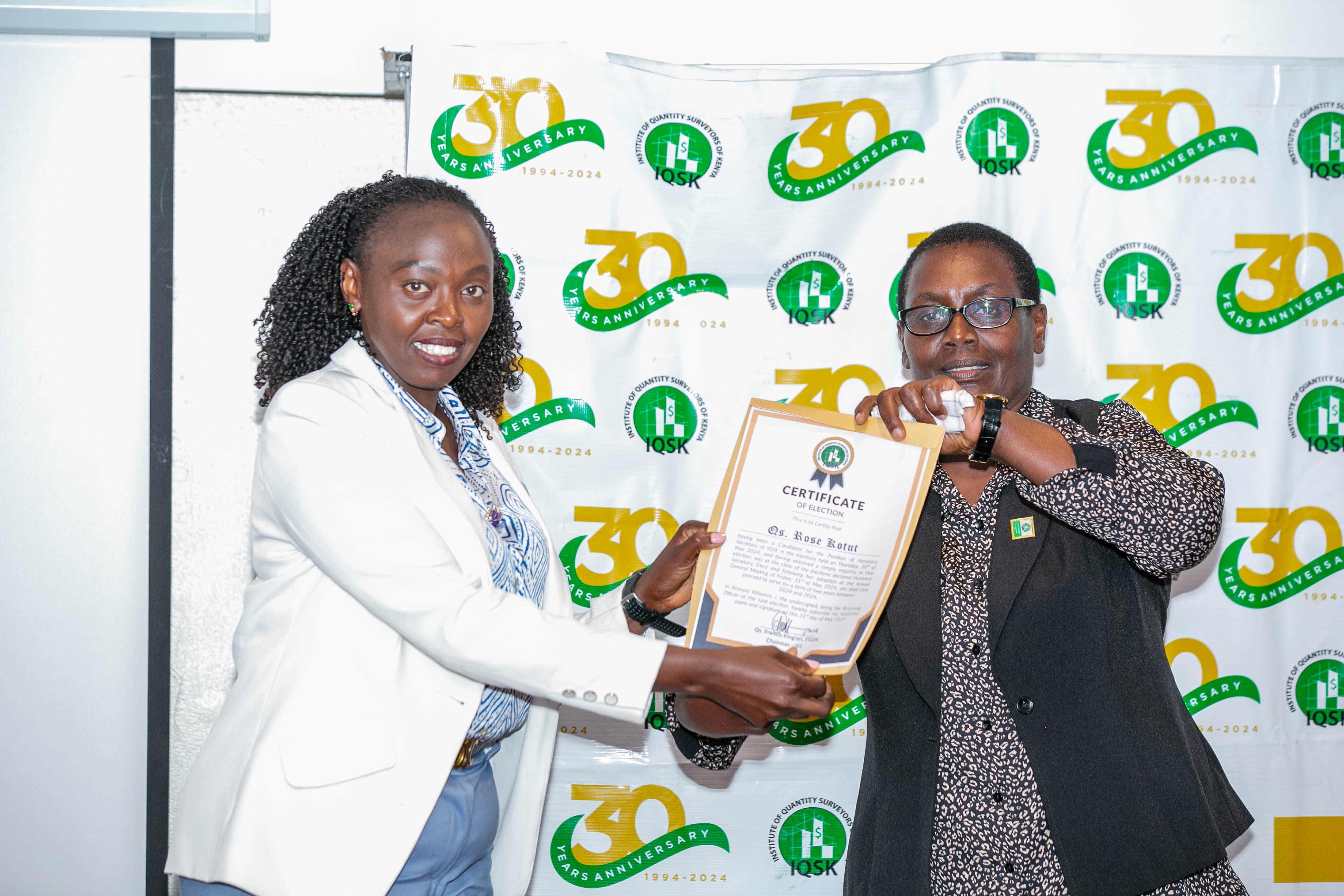 Qs. Rose Kotut receives her Certificate of Election from Commission Vice Chairperson Qs. Gladys Wahome