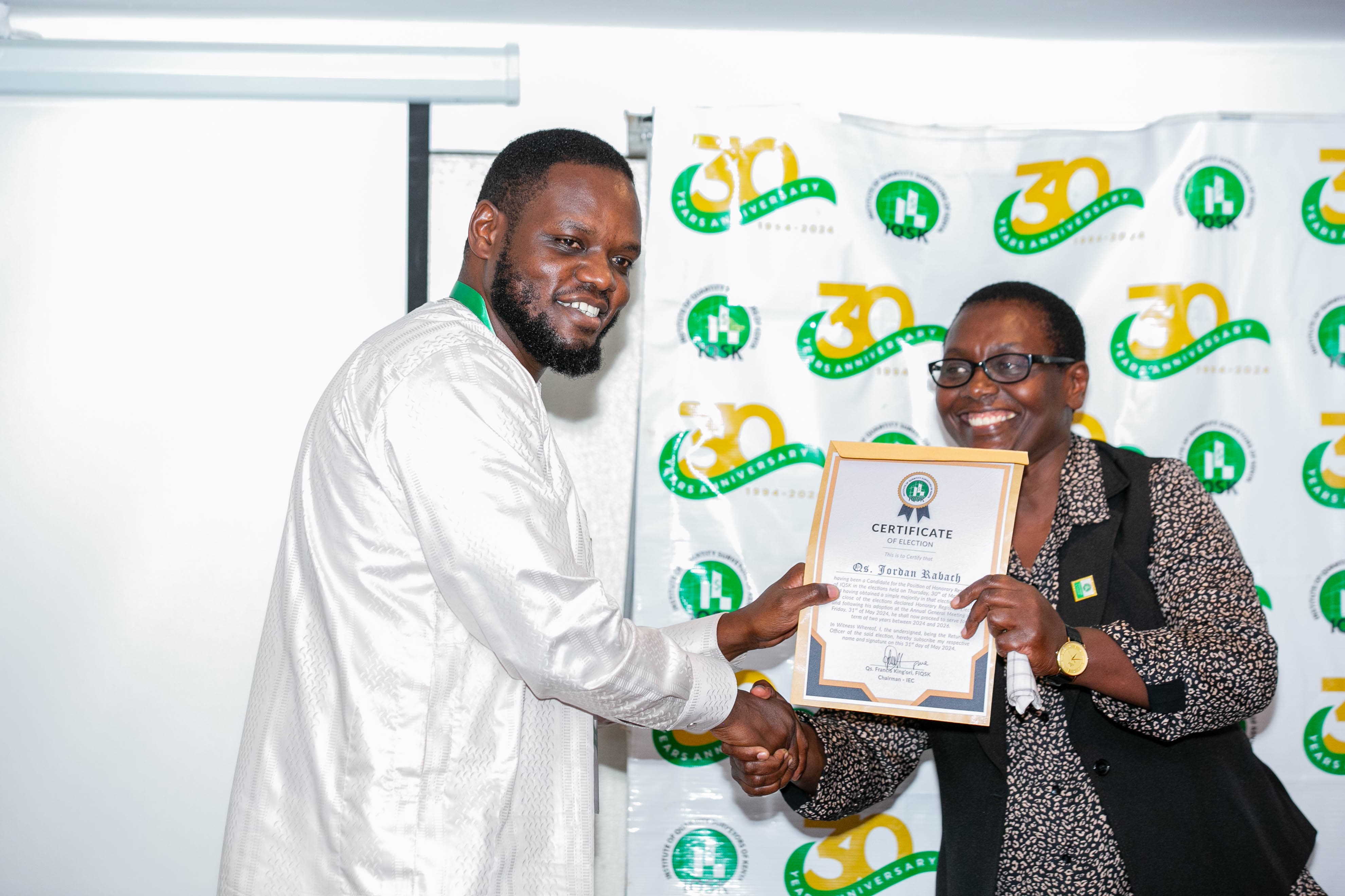 Qs. Jordan Rabach receives his Certificate of Election from Commission Vice Chairperson Qs. Gladys Wahome
