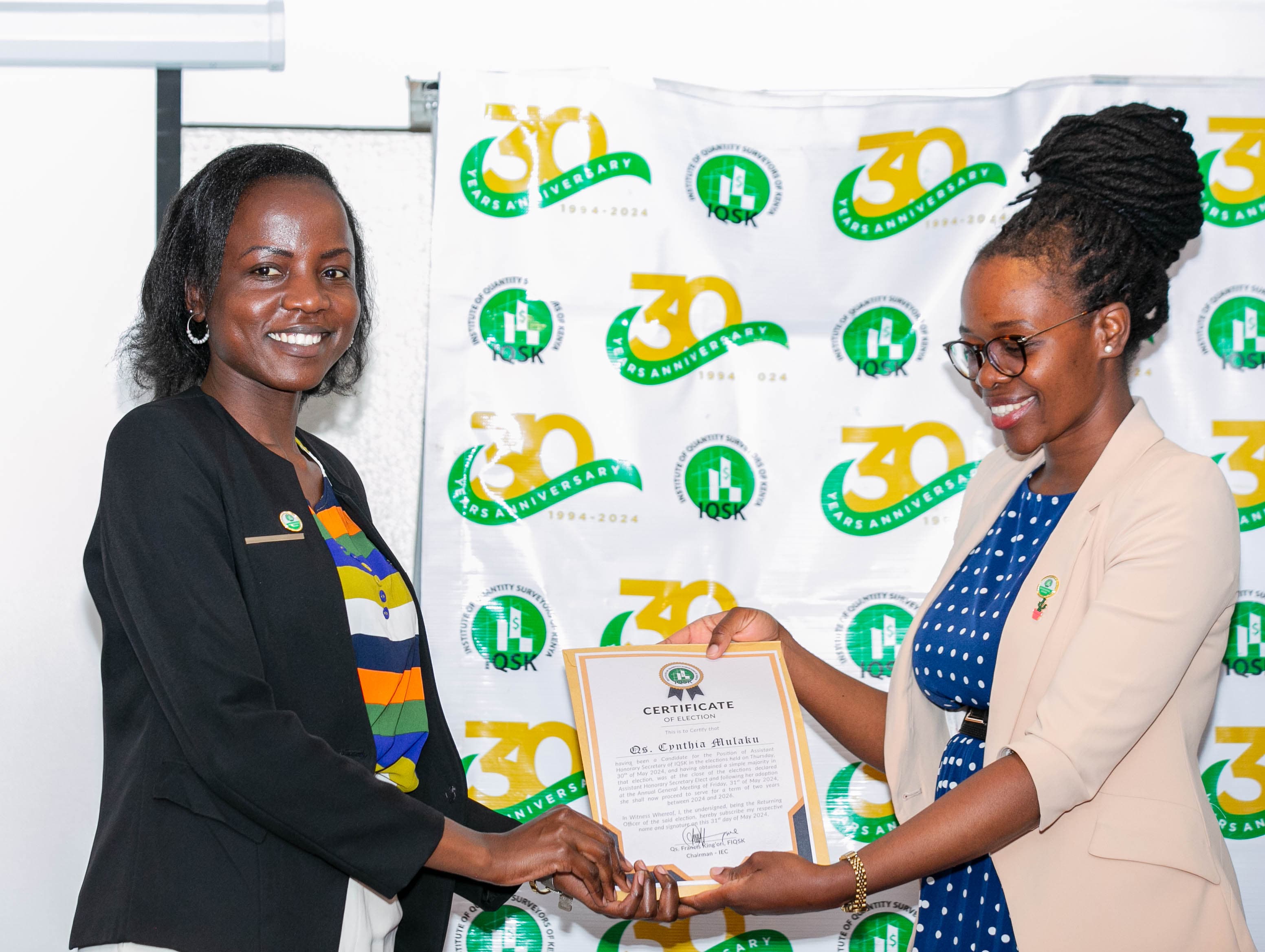 Qs. Cynthia Mulaku receives her Certificate of Election from Commissioner Qs. Portia Kabau
