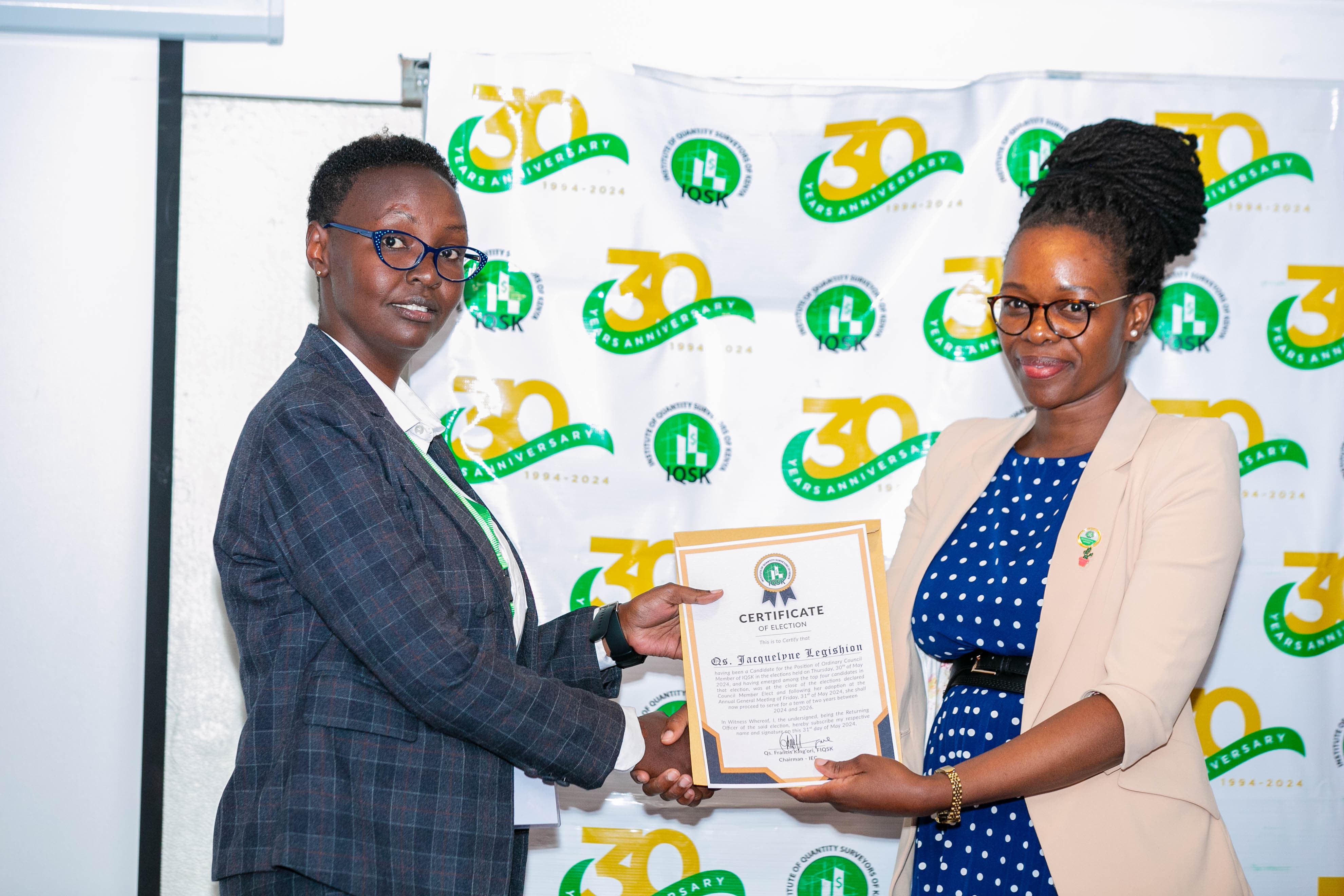 Qs. Jacquelyne Legishion receives her Certificate of Election from Commissioner Qs. Portia Kabau
