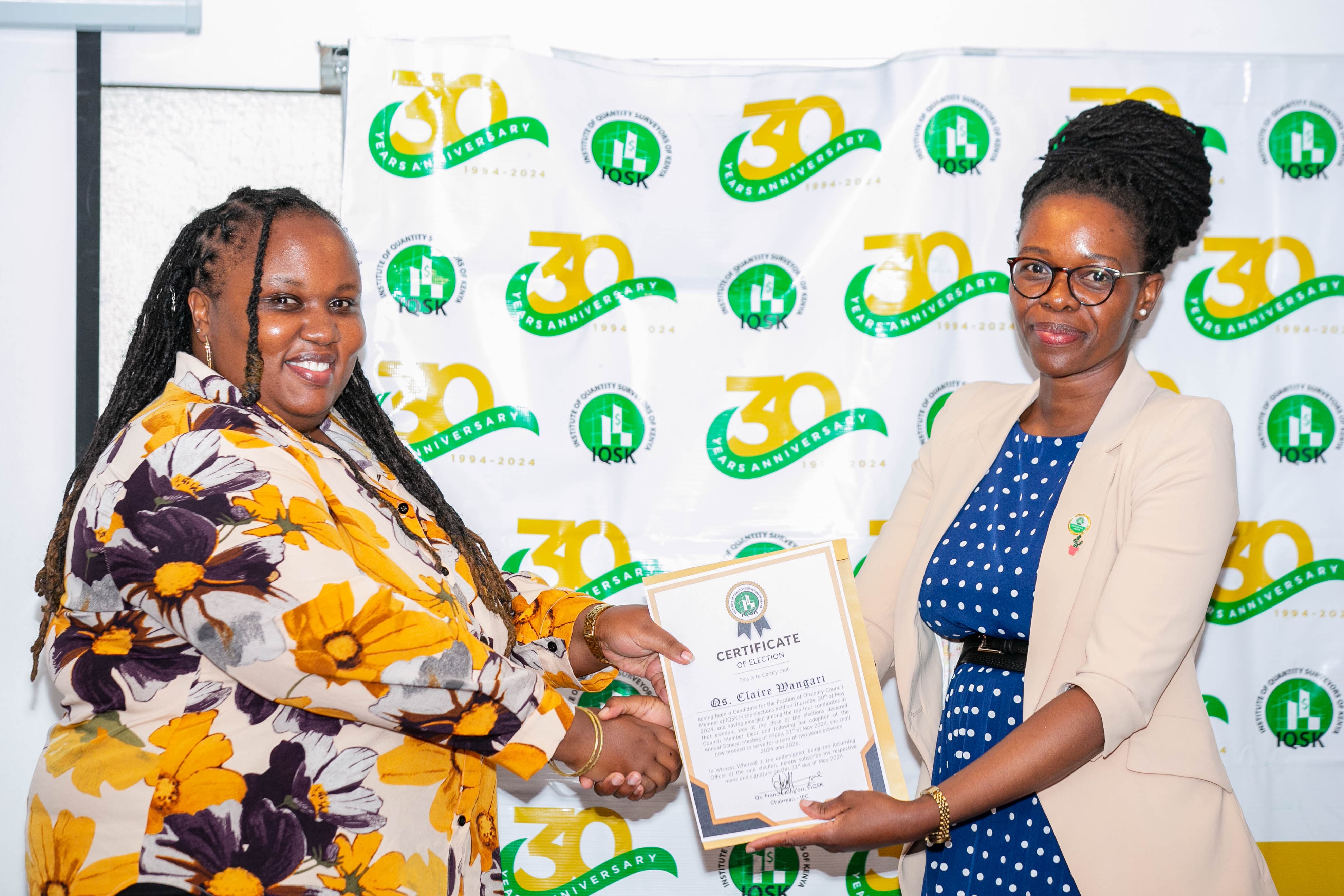 Qs. Claire Wangari receives her Certificate of Election from Commissioner Qs. Portia Kabau